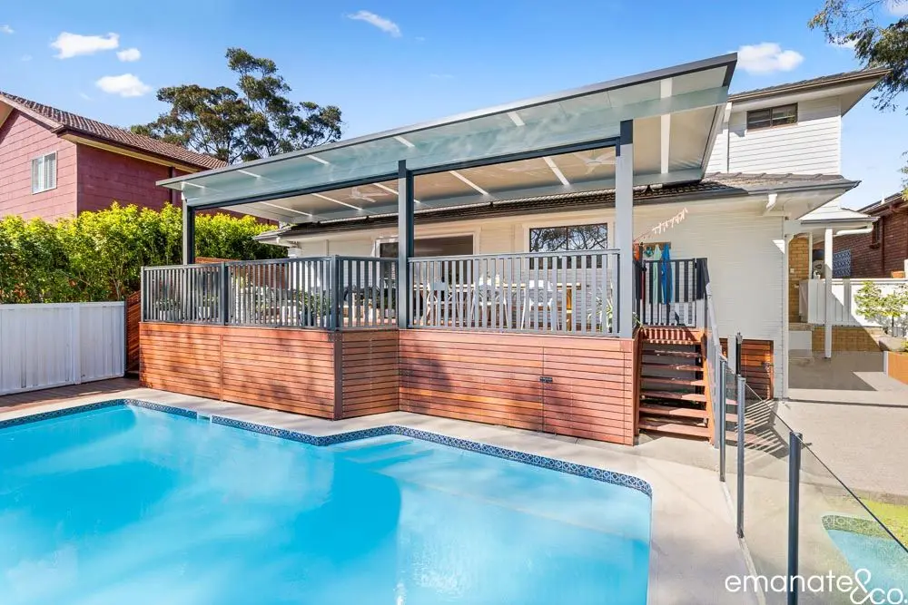 Elevated poolside deck and patio with timber cladding and a sleek roof structure, perfect for relaxed Sydney summer living.