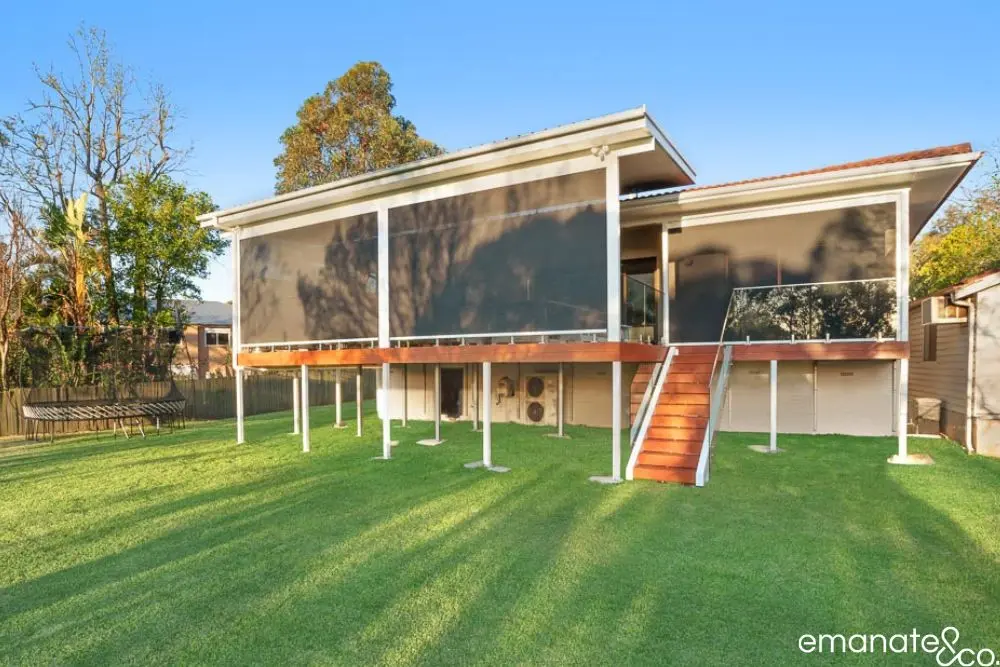 Elevated poolside deck and patio with timber cladding and a sleek roof structure, perfect for relaxed Sydney summer living. BAL-FZ compliant deck and patio in Pymble with modern finishes and bushfire-resistant materials, ideal for safe luxury living.
