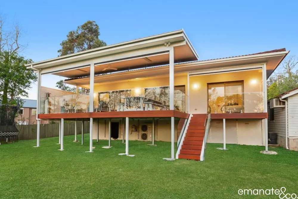 Architecturally designed alfresco renovation in West Pymble featuring hardwood decking, high roofline, and seamless connection to garden surrounds