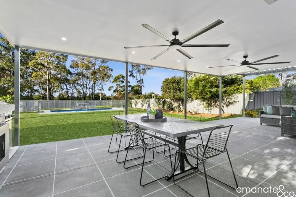 Night view of a modern patio cover ceiling idea with integrated lighting in a Wahroonga home.