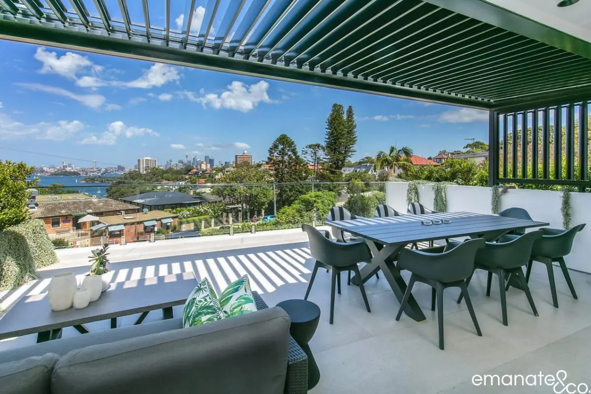 Architectural louvre roof outdoor dining area overlooking Sydney Harbour in Mosman, featuring premium finishes and seamless indoor-outdoor living.