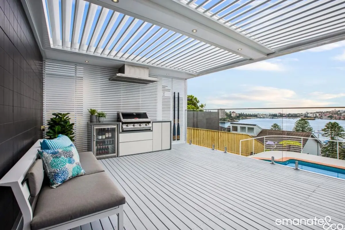 Modern louvre roof alfresco with outdoor kitchen, premium decking and harbour views in Mosman, creating a luxury outdoor entertaining space.