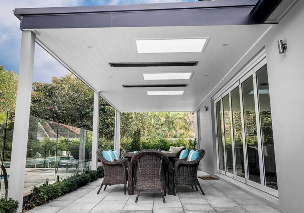 Timber-lined patio cover featuring translucent skylights, strip heaters, and outdoor dining area in West Pymble.