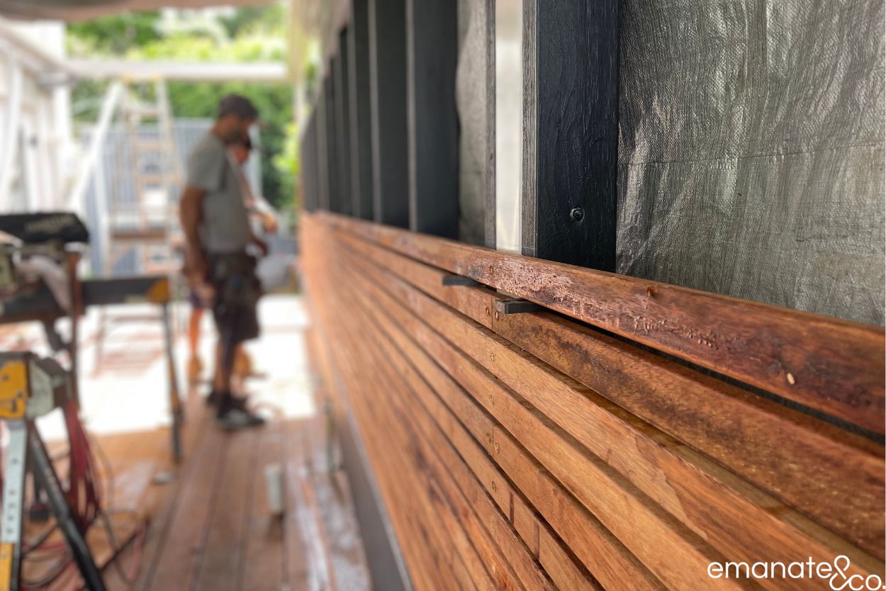 Close-up of custom hardwood privacy screening being installed beside the new timber deck at a Wahroonga outdoor living project.