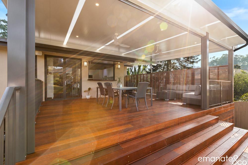 Sunlit Normanhurst outdoor room combining hardwood decking, insulated patio roofing, ceiling fans, recessed lighting, dining and relaxed lounge areas.
