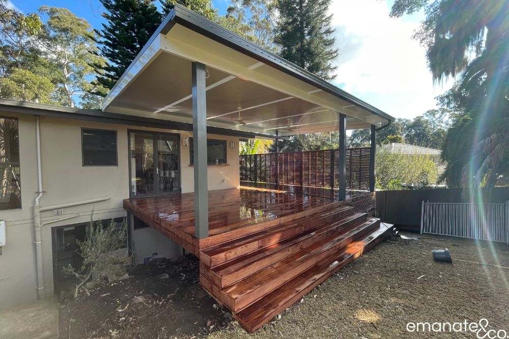 New hardwood deck and insulated patio cover nearing completion in Normanhurst, with broad steps, integrated fans and timber privacy screening.