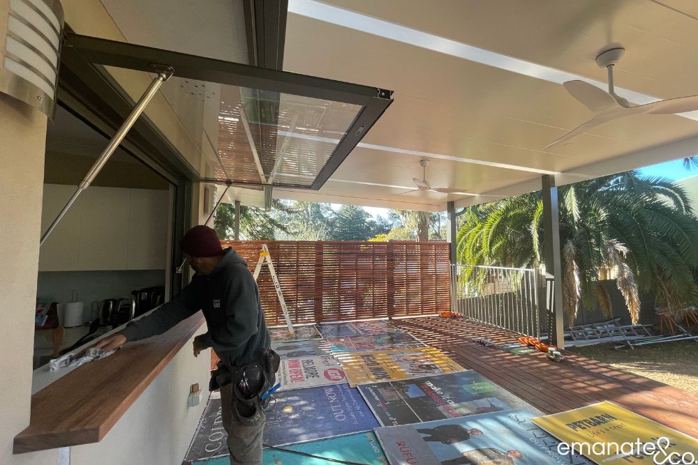 Emanate & Co. builder completing a timber servery beside the hardwood deck, insulated patio roof and privacy screens in Normanhurst.
