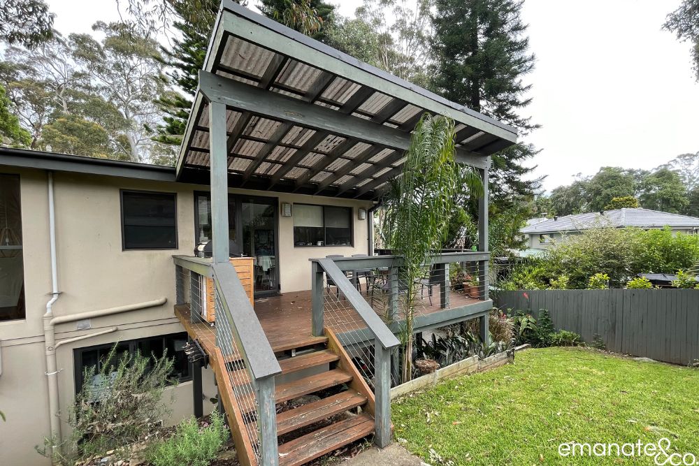 Original raised timber deck and polycarbonate patio roof at the Normanhurst home before its complete outdoor living transformation.