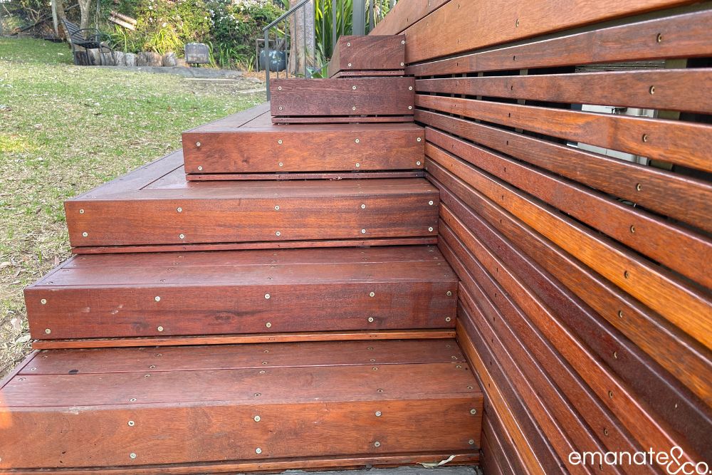 Custom hardwood deck steps and matching privacy screen create a warm, cohesive transition between the Normanhurst outdoor room and garden.