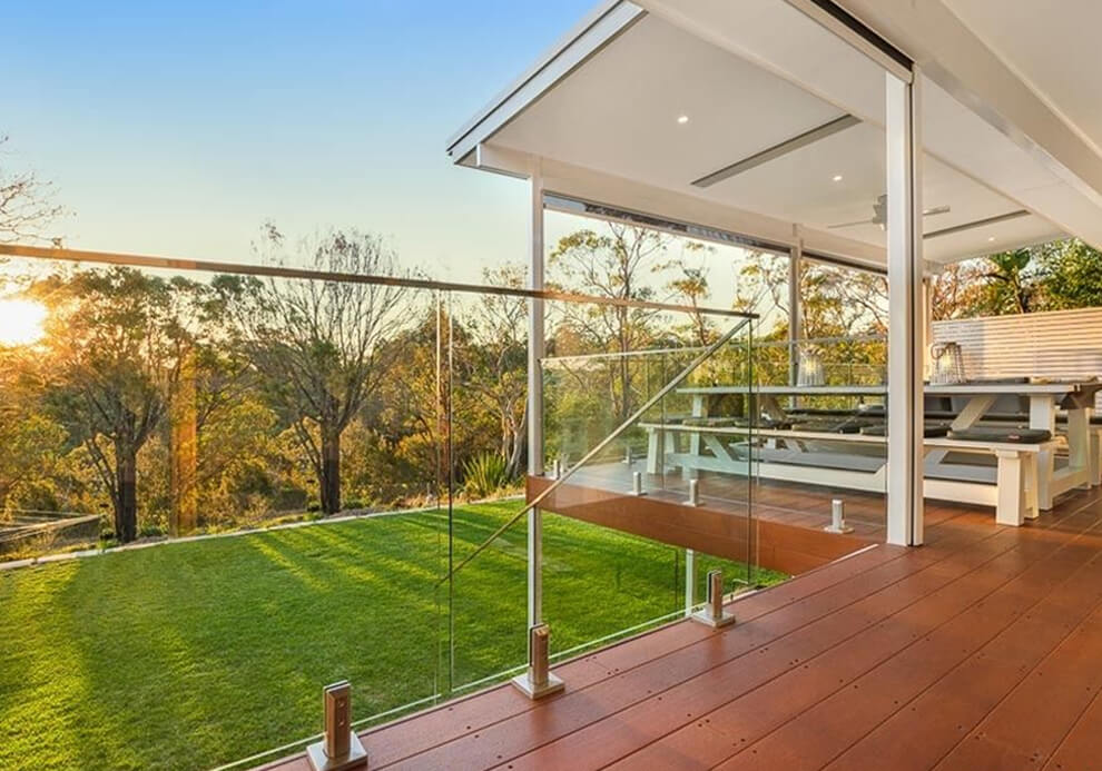 BAL-FZ bushfire-compliant flyover patio cover and elevated deck with glass balustrade in West Pymble by Emanate and Co.