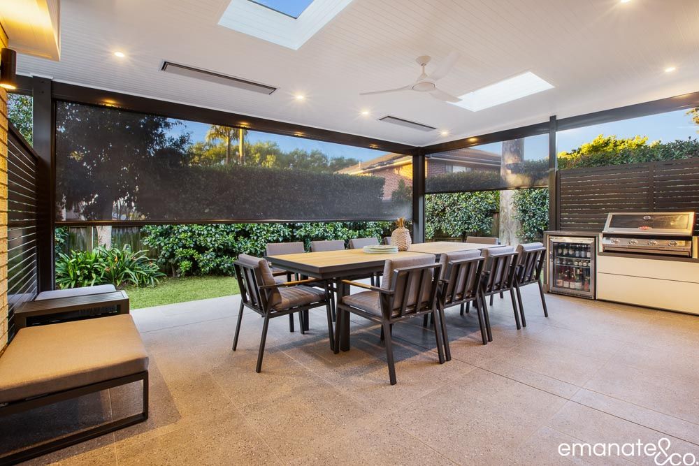 Pennant Hills Hamptons-inspired alfresco with insulated roof, outdoor kitchen, dining area and retractable blinds for comfortable year-round entertaining.