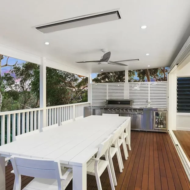Modern alfresco in Hornsby with outdoor kitchen, ceiling fans, and weather-protected deck